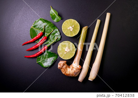 Mix ingredients of tom yum goong on black table, composed of lime, red chili, kaffir lime leaf, lemongrass, galangal.Food top view. 70412838