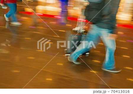 people tourists with travel suitcase luggage in blurred speed motion people tourists with travel suitcase luggage in blurred speed motion 70413016