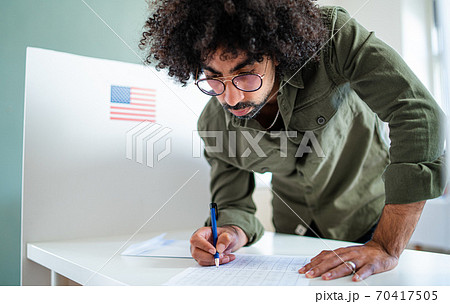 Man voter in polling place, usa elections concept. Man voter in polling place, usa elections concept. 70417505