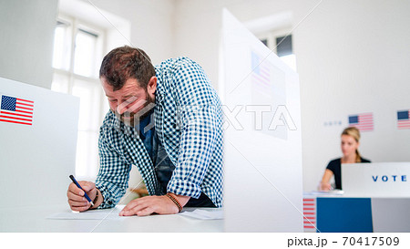 Portrait of man voter in polling place, usa elections concept. 70417509