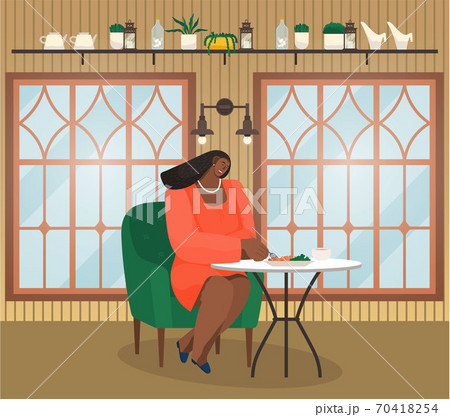 Cafe interior or restaurant, young african woman sitting at table eating, have lunch or dinner Cafe interior or restaurant, young african woman sitting at table eating, have lunch or dinner 70418254