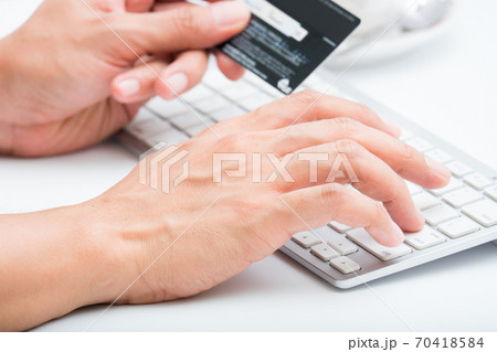 Person entering number of credit card with white 70418584