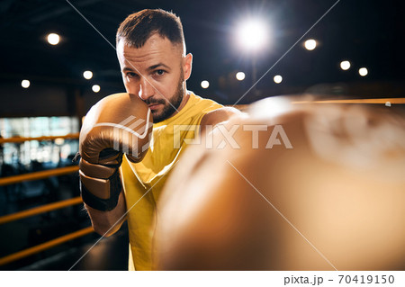 Collected fighter attacking his opponent with a punch 70419150