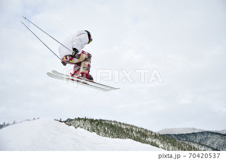 Winter kinds of sport. Skier doing tricks in the mountains in winter season 70420537