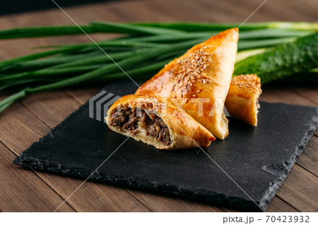 Cut oriental dish baked pie with meat samsa 70423932