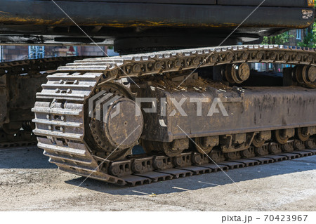 Roller and track of a large self-propelled machine close up 70423967
