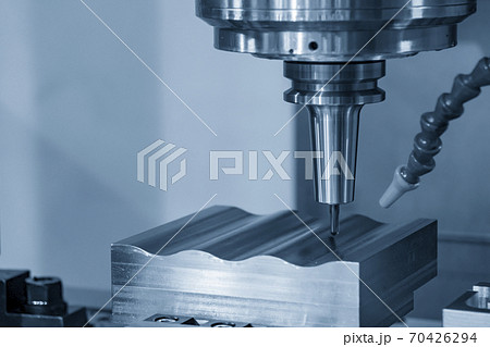 The CNC milling machine cutting the mold parts. The CNC milling machine cutting the mold parts. 70426294