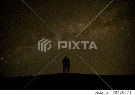 The couple standing on the sky with stars background The couple standing on the sky with stars background 70426571