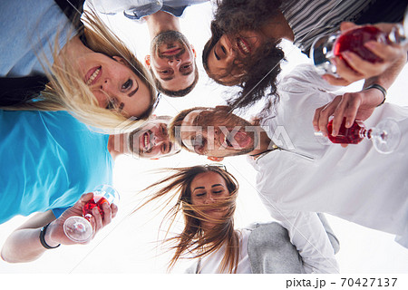 summer vacation, happy people - a group of teenagers looking down with a happy smile on his face. summer vacation, happy people - a group of teenagers looking down with a happy smile on his face. 70427137