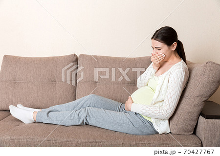 Pregnancy Morning Sickness. Pregnant Woman Having Nausea Feeling Bad in Sofa at the Home 70427767
