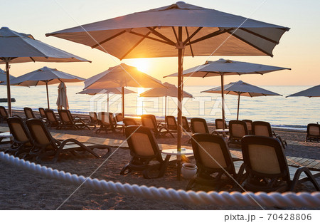 Scenic view of sandy beach on the beach with sun beds and umbrellas open against the sea and mountains. Hotel. Resort. Tekirova-Kemer 70428806