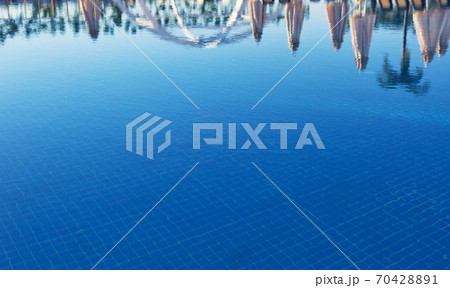 Clear blue water in the pool, through the sunlight. Water background 70428891