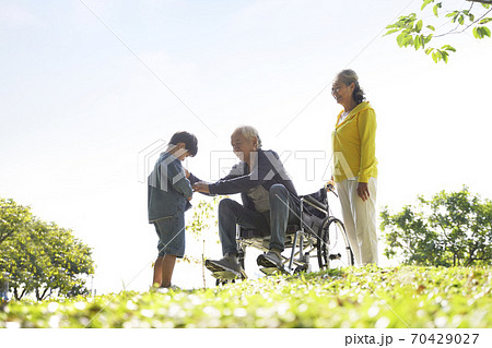 asian grandfather grandmother and grandson having fun outdoors in park 70429027