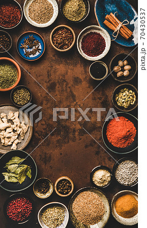 Flat-lay of spices in bowls over rusty background Flat-lay of spices in bowls over rusty background 70430537