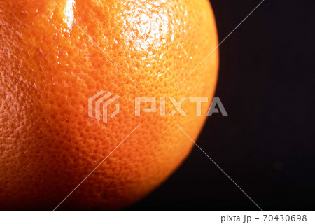 macro fresh orange peel on a black background. macro fresh orange peel on a black background. 70430698