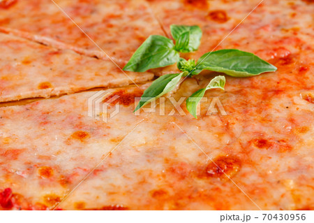 Pizza margarita on wooden board on dark background. Close-up 70430956