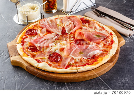 Pizza with salami and prosciutto 70430970