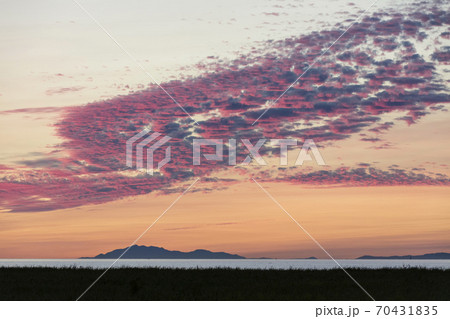 Beach sunset with crimson clouds 70431835