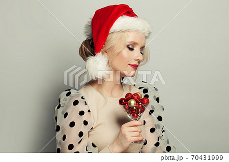 Pretty woman Santa making a wish. Christmas holiday and New Year party portrait Pretty woman Santa making a wish. Christmas holiday and New Year party portrait 70431999