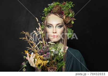 Nymph woman with wild flowers on black background 70432033
