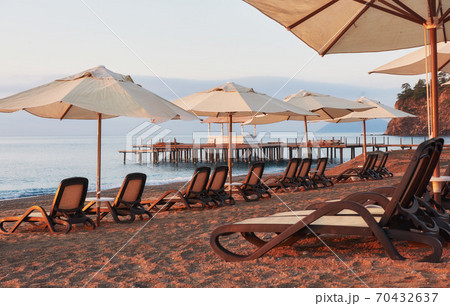 Scenic view of private sandy beach on the beach with sun beds against the sea and mountains. Amara Dolce Vita Luxury Hotel. Resort. Tekirova-Kemer Scenic view of private sandy beach on the beach with sun beds against the sea and mountains. Amara Dolce Vita Luxury Hotel. Resort. Tekirova-Kemer 70432637