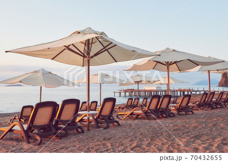 Scenic view of private sandy beach on the beach with sun beds against the sea and mountains. Amara Dolce Vita Luxury Hotel. Resort. Tekirova-Kemer Scenic view of private sandy beach on the beach with sun beds against the sea and mountains. Amara Dolce Vita Luxury Hotel. Resort. Tekirova-Kemer 70432655
