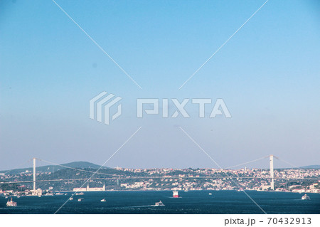 Mosque minarets and Bosphorus bridge in Istanbul in Turkey and the sea of Marmara on background 70432913