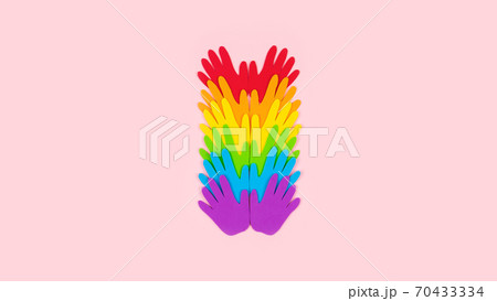 Tolerance, kindness, cooperative, friendship, charity humanitarian aid day concept. Many rainbow color palm hands on pink background with copy space 70433334