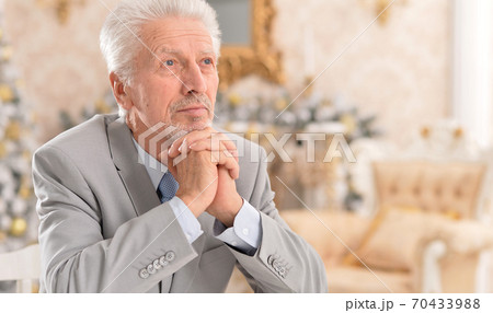 Close-up portrait of cute senior man thinking 70433988