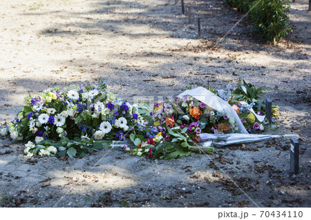 Flowers on a new grave in a cemetery Flowers on a new grave in a cemetery 70434110
