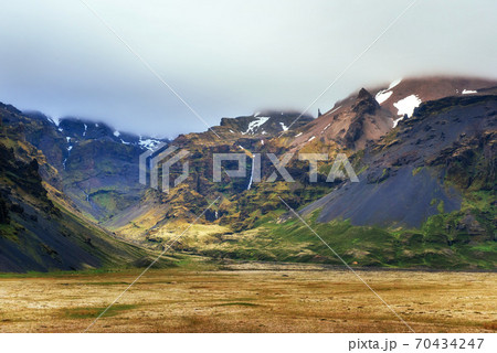 Gentle slopes of snow-capped mountains and glaciers. Wonderful Iceland in the spring. 70434247