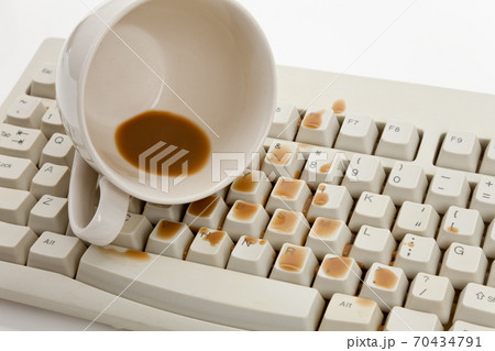 Coffee and damaged computer keyboard 70434791