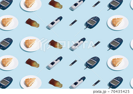Glucose meter and plate with pie on blue background with shadow, Metabolic syndrome concept Glucose meter and plate with pie on blue background with shadow, Metabolic syndrome concept 70435425