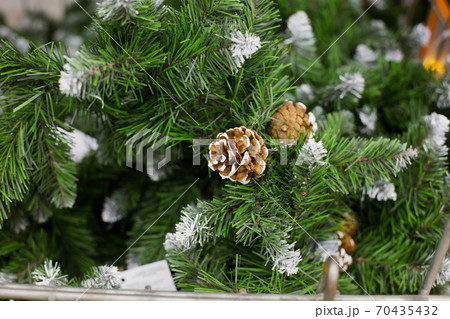 brown cone on artificial Christmas tree, close-up brown cone on artificial Christmas tree, close-up 70435432