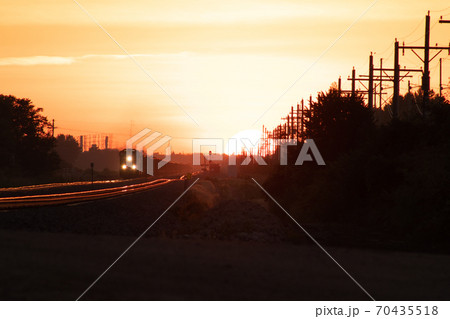 Rail Road crossing and tracks at sunset Rail Road crossing and tracks at sunset 70435518
