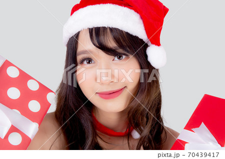 Beautiful portrait young asian woman happy holding red gift box with excited in xmas holiday. 70439417