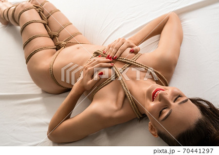 Alluring naked woman tied with ropes Alluring naked woman tied with ropes 70441297