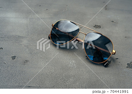 New dark aviator glasses on grey concrete background New dark aviator glasses on grey concrete background 70441991