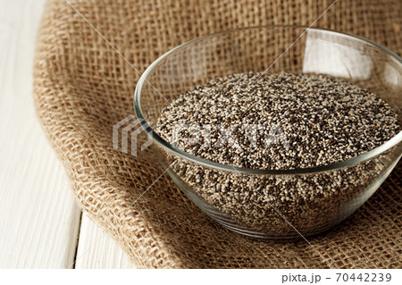 Glass bowl with chia seeds on wooden table Glass bowl with chia seeds on wooden table 70442239