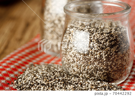 Glass bowl with chia seeds on wooden table Glass bowl with chia seeds on wooden table 70442292
