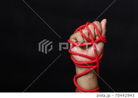 Woman hand tied up with rope 70442943