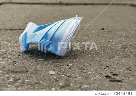 The used mask lies on the road The used mask lies on the road 70443491