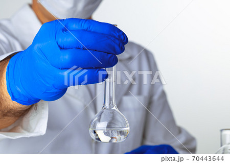 Close up of hands of a scientist working with laboratory samples 70443644