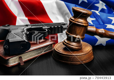 Gavel on wooden table with USA flag Gavel on wooden table with USA flag 70443913