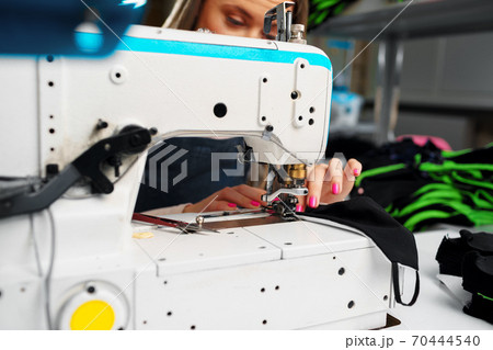 Close up of a seamstress with a sewing machine 70444540