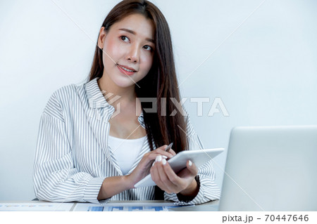 Businesswoman holding tablet and analysis the chart with laptop at the office for setting challenging business goals And planning to achieve the new target 70447646