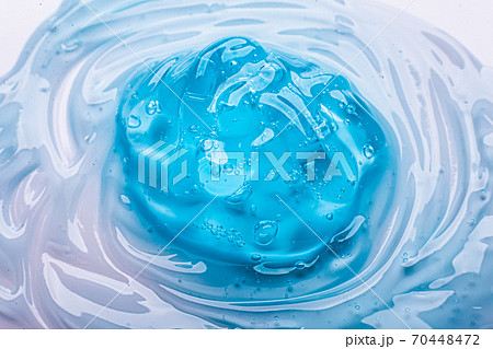 Squeezed cosmetic clear cream gel texture Iisolated on white background. Close up transparent serum drop 70448472