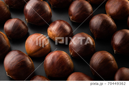 Rows of chestnuts isolated on black background 70449362