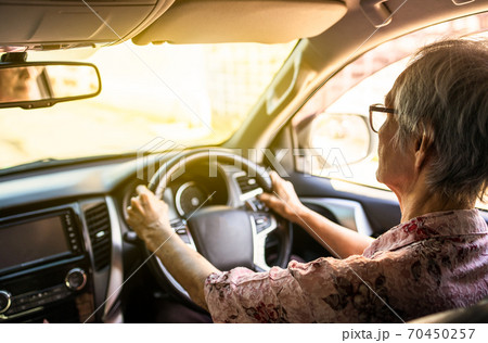 Concentrated senior woman driver hold steering wheel steady using slow speed to avoid accidents,asian elderly people driving careful,concentrating while driving car in city,traffic,road safety concept Concentrated senior woman driver hold steering wheel steady using slow speed to avoid accidents,asian elderly people driving careful,concentrating while driving car in city,traffic,road safety concept 70450257