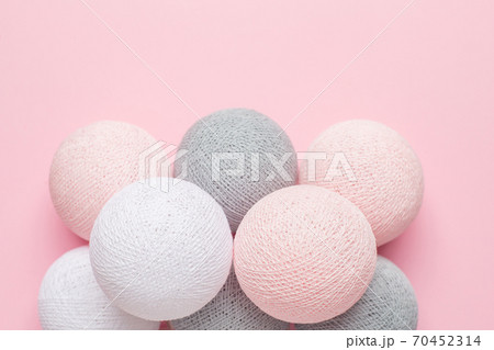 Pink, grey and white balls on a pastel background 70452314
